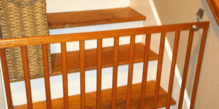 Old crib rail repurposed as a baby gate
